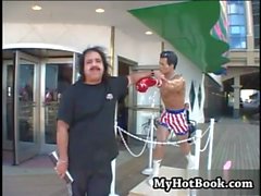 Solara Star lays on the bed next to Ron Jeremy wh