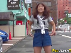 Asian leaves piss puddle in public street