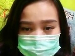 Playful Indonesian hottie wears a facemask while rubbing