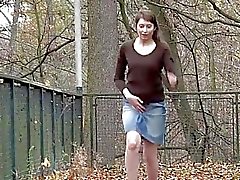 Hairy girl lifts her skirt and pisses outdoors