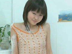 Cute young Asian Aliona plays alone in the bathtub to