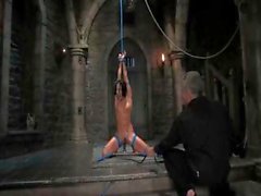 Brunette tied up and suspended in BDSM clip as he tortures her